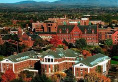 an aerial view of the campus and surrounding buildings in fall colors with mountains in the background