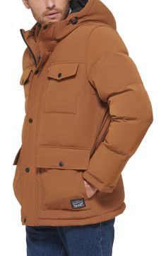 A padded puffer jacket features a classic four pocket design and attached hood. 30" length (size M) Long sleeves Front closure Exterior 4 pockets 100% polyester Machine wash Imported Model stats: 6'0" height; 33" waist. Model is wearing size M. Brown Winter Puffer Jacket With Pockets, Fitted Nylon Puffer Jacket With Pockets, Fitted Nylon Outerwear With Pockets, Hooded Quilted Down Jacket With Pockets, Casual Solid Quilted Jacket With Pockets, Fall Puffer Jacket With Pockets For Outdoor Activities, Hooded Down Puffer Jacket With Pockets, Casual Solid Parka With Padded Collar, Fitted Hooded Puffer Jacket With Pockets