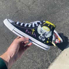 Local designer Austin Cook shares his primary logo on the classic silhouette of a high top Converse. In addition, there are some added custom "chalk" effects. Consequential Clothing is derived from an infatuation with the concept of the "butterfly effect" as well as an interest in the dichotomy of life and death. With a boutique style twist on modern fashion, Consequential Clothing is showing why it's on the rise. We source each pair of blank shoes brand new directly from Converse. Each pair is Custom Vans Slip On, Converse Shoes Men, Black Slip On Vans, Custom Converse Shoes, The Butterfly Effect, High Top Converse, Angel Devil, Custom Converse, Stunning Shoes