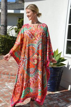 "This beautiful silk caftan is a design from Hermes called \"le Jardin de la Maharani Recadre\". It was designed as a tribute to Maharani of Jaipur who devoted her life to the support of the women of India. It is an intricate, mixed design with colors of orange, reds, green and pinks, with a pink border outlining it all. The generous amount of silk fabric adds to its elegance and beautiful flow. Appropriate for so many occasions. One size. It fits many sizes from small to X-Large. The width, edg Multicolor Silk Printed Tunic, Bohemian Silk Multicolor Print Dress, Bohemian Silk Dress With Multicolor Print, Bohemian Multicolor Print Silk Dress, Silk Multicolor Print Beach Dress, Multicolor Print Silk Dress For The Beach, Multicolor Silk Dress For Beach Cover-up, Multicolor Free Size Silk Dress, Multicolor Free-size Silk Dress