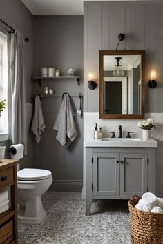 a white toilet sitting next to a sink in a bathroom under a mirror and lights