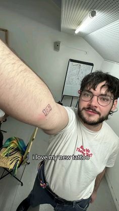 a man with a small tattoo on his arm