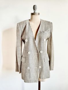 "This stunning little 90s blazer with the perfect neutral plaid pattern is a perfect closet staple. Wear this dressed up with vintage jeans and a pair of heels or dressed down with a simple tee and a pair of sneakers. It's made of a very soft fabric that may have some silk although not marked. | Details | Modern Size: Small Materials: Tweed Condition: Excellent vintage condition | Measurements | all measurements are taken while laying flat Shoulders: 16 inches Bust: 17 inches Waist: 14.5 inches Elegant Plaid Blazer With Double Button Closure, Spring Formal Plaid Blazer, Elegant Double-breasted Plaid Blazer, Vintage Workwear Blazer With Double Button, Vintage Workwear Blazer With Double Button Closure, Chic Double-breasted Plaid Blazer, Vintage Plaid Blazer With Notch Lapel, Retro Plaid Formal Blazer, Retro Plaid Blazer For Formal Occasions