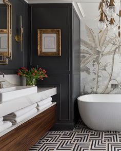 a bath room with a tub a sink and a mirror on the wall in it