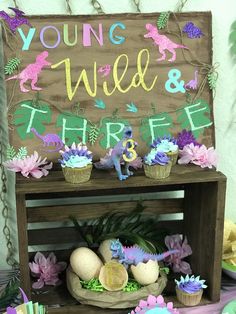 there is a sign that says young wild and three eggs in front of some flowers