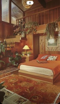 a bed sitting in the middle of a bedroom next to a plant filled wall with potted plants