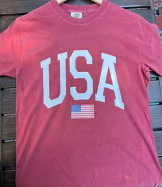 Comfort Colors Flag T- shirt ------DETAILS------ Design made with high quality vinyl, not printed. Design is heat pressed onto garment using vinyl Can be machine washed and dried For longer durability, turn inside out, wash cold and lay out to dry ------ SHIRT ------ 100% ring spun USA cotton Preshrunk, soft-washed, garment-dyed fabric Made with sustainably and fairly grown USA cotton and sewn with USA cotton thread Double-needle stitched sleeves and bottom hem vintage feel relaxed, less fitted Logo Shirt, Flag Shirt, Flag Tshirt, Dyed Fabric, Usa Flag, Printed Design, Cotton Thread, Fourth Of July, Comfort Colors