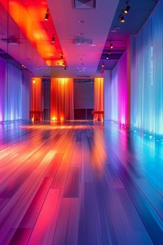 a brightly lit room with wooden floors and colorful lights on the walls, along with drapes