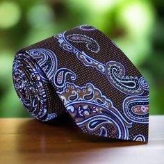 A Timeless Accessory: Shades of Brown, Light Blue, and Pink Paisley Silk Necktie Add a touch of sophistication to your wardrobe with this exquisite silk necktie featuring a harmonious blend of shades of brown, light blue, and pink in a classic paisley pattern. Available in both traditional width (3.25 inches) and a modern, slim design (2.5 inches), this versatile tie comes in regular (60 inches) and extra-long (63 inches) lengths. You can purchase it with a matching pocket square, an accenting d Elegant Multicolor Standard Tie, Elegant Multicolor Formal Neckwear, Elegant Paisley Print Suit And Tie Accessories For Gift, Elegant Paisley Print Tie As A Gift, Elegant Paisley Print Ties As Gift, Elegant Multicolor Neckwear With Ties, Elegant Multicolor Neckwear For Business, Elegant Multicolor Business Neckwear, Elegant Multicolor Ties As A Gift