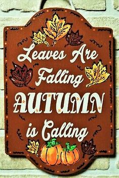 a sign that says leaves are falling autumn is calling on the side of a brick wall