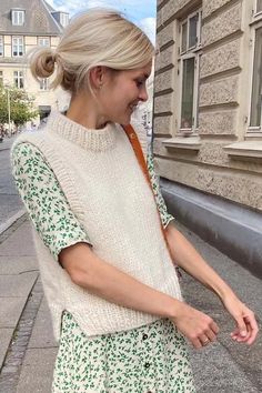 a woman walking down the street with her hand in her pocket