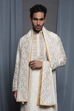 Ecru chanderi stole with floral embroidered border.
Pattern: Embroidered
Type Of Work: Floral
Fabric: Chanderi
Color: Cream
Other Details: 
Note: Pant and kurta worn by the model is not for sale
 - Aza Fashions Traditional Chanderi Sherwani With Dupatta, Chanderi Sherwani With Dupatta For Traditional Ceremonies, Ceremonial Silk Sherwani With Dupatta, Silk Sherwani With Dupatta For Ceremonial Occasions, Beige Jamawar Dupatta With Intricate Embroidery, Festive Ceremonial Shawl With Embroidered Border, Chanderi Kurta With Embroidered Border For Wedding, Wedding Chanderi Kurta With Embroidered Border, Unstitched Tussar Silk Sherwani For Wedding