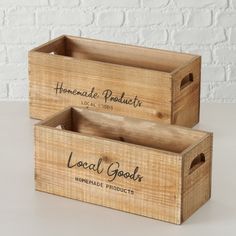 two wooden boxes with the words local goods written on them and labeled home made products