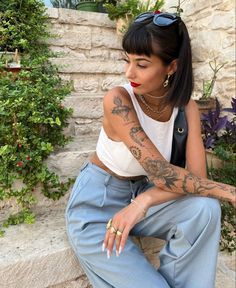 a woman with tattoos sitting on the steps