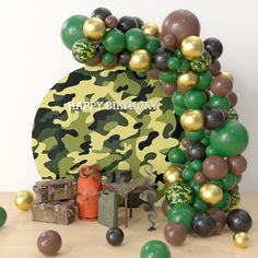 an army themed birthday party with balloons and camouflage theme, including the number one balloon arch