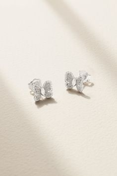 De Beers' 'Portraits of Nature' earrings will make a transformative addition to your sparkling collection. Crafted from 18-karat white gold in the shape of a butterfly, they're illuminated by a dusting of pavé stones tracing the sculpted wings and have a singular marquise-cut diamond at the heart. White Platinum Drop Earrings, White Diamond Cut Fine Jewelry Earrings, White Platinum Earrings Fine Jewelry, Luxury White Earrings With Pave Setting, Luxury White Pave Set Earrings, White Diamond Cut Platinum Earrings, Silver Earrings With Pave Setting In Fine Jewelry Style, Silver Earrings With Pave Setting, Luxury White Diamond Earrings In Sterling Silver