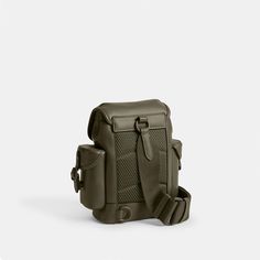 an olive green leather shoulder bag on a white background with the strap down to it's front pocket