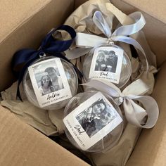 three personalized christmas ornaments in a box with ribbons and ribbon around the ornament