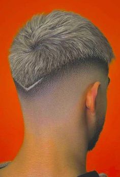 the back of a man's head with grey hair and shaved undercuts