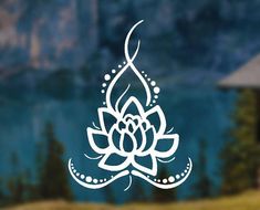 an image of a white lotus flower on a glass window with mountains in the background