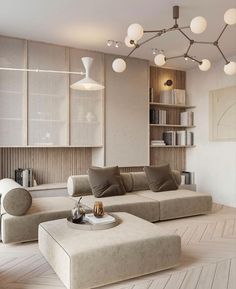 a living room filled with furniture and bookshelves next to a wall mounted book shelf