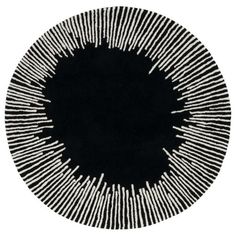 a black and white circular rug with lines on it