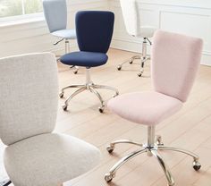 four different colored office chairs in a room