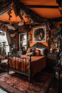 a bedroom decorated in orange and black with pictures on the wall above the bed, along with an area rug