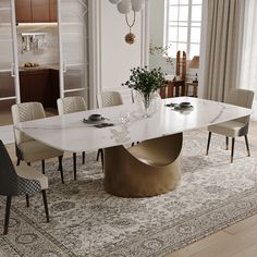 a dining room table with chairs and a rug on the floor in front of it