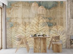 a dining table and chairs in front of a wall mural