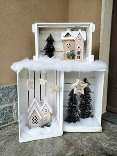 two white shelves with christmas decorations on them