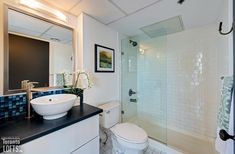 a bathroom with a sink, toilet and bathtub next to a walk in shower