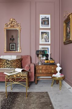 a living room filled with furniture and pictures on the wall