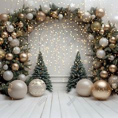 two christmas trees with gold and silver ornaments in front of a white wall decorated with lights