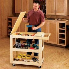 a man standing next to a workbench with tools on it in a kitchen