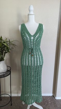 Indulge in versatile elegance with this light green crochet maxi mesh dress, an exquisite piece that seamlessly transitions from a sunny beach day to a captivating night out. Its airy mesh fabric exudes a breezy charm, while the maxi length adds a touch of sophistication. Whether worn over swimwear for a leisurely stroll along the shoreline or paired with statement accessories for an evening soirée, this dress effortlessly embodies both style and comfort. With its soft hue evoking the serenity of a summer breeze, it's an essential addition to any wardrobe, promising effortless allure wherever the day takes you. CUSTOM MADE ORDER: Choose the color, size, and material for a unique product. Experience the perfect combination of style and functionality with custom options tailored to your liki Spring V-neck Crochet Beach Dress, Spring Crochet Lace Dress For Beach Cover-up, Summer Lace Maxi Dress For Beach Season, Summer Sheer Lace Maxi Dress, Summer Lace Maxi Dress For Beach, Summer Lace Maxi Dress For The Beach, Green V-neck Beachy Maxi Dress, Lace Maxi Dress For Beach Season, Lace Maxi Dress For Beach