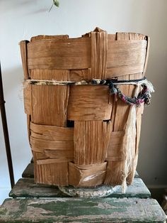 a large wooden basket sitting on top of a table