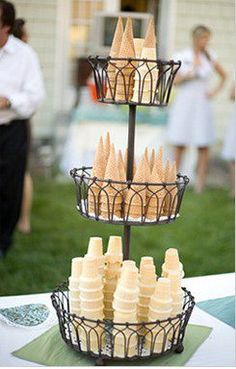 three tiered trays filled with pastries on top of a table