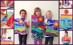 children holding colorful paintings and smiling for the camera