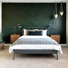 a bed sitting in a bedroom next to a wall with plants on top of it