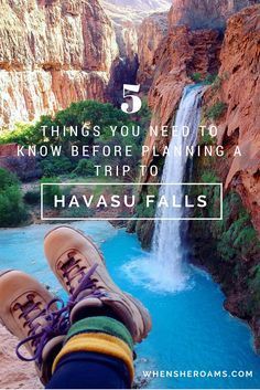 a person's feet hanging over the edge of a cliff with a waterfall in the background