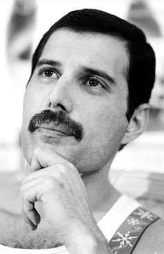 a black and white photo of a man with a moustache on his face