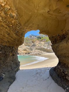 an arch in the sand leading to a beach