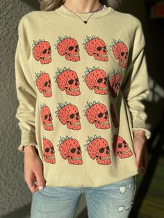 A hand drawn Strawberry Skull crew neck is the perfect gift for any occasion! Comes in size S-5XL.  Ideal for any situation, a unisex heavy blend crewneck sweatshirt is pure comfort. These garments are made from polyester and cotton. This combination helps designs come out looking fresh and beautiful. The collar is ribbed knit, so it retains its shape even after washing. There are no itchy side seams on these sweaters. .: 50% cotton, 50% polyester .: Medium-heavy fabric (8.0 oz/yd² (271.25 g/m . Casual Sweatshirt With Custom Print For Streetwear, Skull Print Crew Neck Sweatshirt For Streetwear, Streetwear Skull Print Crew Neck Sweatshirt, Casual Skull Print Sweatshirt For Streetwear, Casual Sweatshirt With Custom Print And Crew Neck, Casual Sweatshirt With Skull Print For Streetwear, Casual Crew Sweatshirt With Custom Print, Cotton Band Merch Sweatshirt With Skull Print, Casual Sweatshirt With Custom Artwork For Streetwear