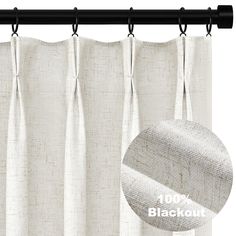 white curtains with black rod ends hanging on a curtain rod