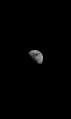 the moon is seen in the dark sky