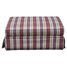 the footstool is made out of plaid fabric