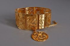 "Mid-century or earlier Straits Chinese Yin Yang bracelet set in 22k. The dragon-phoenix is hand-carved in four pairs, with a whimsical hanging charm characteristic of such bracelets. The carving is exquisite, even if repetitive, such that its single-sided expression is an elegance. Each screen is contoured, wave to wave, a mark of fine craftsmanship. The pierced gold work is also considered thick for these screen or book fold bracelets, giving us a 'book piece' both deft and strangely delicate, Yin Yang Bracelet, Chinese Gold, Figural Jewelry, Dragon Phoenix, Chinese Jewelry, Book Pieces, Yellow Gold Jewelry, Jewelry Fashion Trends, Gold Work