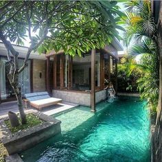 an outdoor swimming pool surrounded by trees