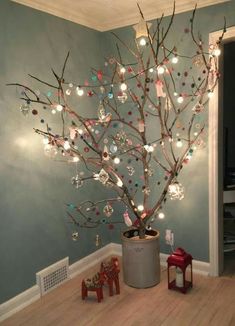 a christmas tree in a room with lights on the branches and ornaments hanging from it